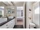 Stylish bathroom showcasing double vanities, dark wood floors, and a glimpse into an adjacent bedroom at 114 Cherry Creek Cir, Winter Springs, FL 32708