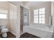 Bright bathroom featuring a soaking tub with shutters and a tiled glass-enclosed shower at 114 Cherry Creek Cir, Winter Springs, FL 32708