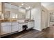 Bathroom with double vanity, granite countertops, wood floors, and a large mirror at 114 Cherry Creek Cir, Winter Springs, FL 32708