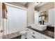 Bright bathroom with a modern vessel sink, granite countertop, and a shower with decorative curtain at 114 Cherry Creek Cir, Winter Springs, FL 32708