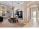 Formal dining area featuring neutral tones, an elegant chandelier, and natural light streaming through large windows at 114 Cherry Creek Cir, Winter Springs, FL 32708