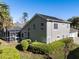 View of home with screened in porch, solar panels, trimmed hedges, and well-manicured lawn at 114 Cherry Creek Cir, Winter Springs, FL 32708