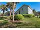 Charming home exterior with lush landscaping, screened-in patio, and swaying palm trees at 114 Cherry Creek Cir, Winter Springs, FL 32708