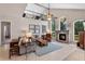 Elegant living room with high ceilings, fireplace, and wrought iron balcony overlooking the space at 114 Cherry Creek Cir, Winter Springs, FL 32708