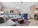 Bright upstairs living room featuring comfortable seating, decorative pillows, and a ceiling fan at 114 Cherry Creek Cir, Winter Springs, FL 32708