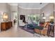 Neutral-toned living room featuring comfortable seating, decorative furnishings, and a view of the outdoor scenery at 114 Cherry Creek Cir, Winter Springs, FL 32708