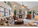 Spacious living room featuring a fireplace, high ceilings, and natural light at 114 Cherry Creek Cir, Winter Springs, FL 32708