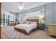 Serene main bedroom with plantation shutters, a wicker bed, and soft, calming colors at 114 Cherry Creek Cir, Winter Springs, FL 32708