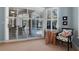 Cozy sitting area in main bedroom, featuring pool view through white-shuttered doors at 114 Cherry Creek Cir, Winter Springs, FL 32708