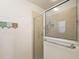 Tiled walk-in shower featuring clear sliding glass door and a built-in shelf at 1197 Eureka Mill Run, The Villages, FL 32162