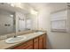 A spacious bathroom with double sinks, a large mirror, and natural lighting at 1197 Eureka Mill Run, The Villages, FL 32162