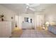 Bright main bedroom featuring a ceiling fan, white furniture, and neutral carpeting at 1197 Eureka Mill Run, The Villages, FL 32162