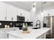Modern kitchen featuring stainless steel appliances, a quartz countertop, a stylish backsplash, and sleek cabinetry at 12255 Sw 98Th St, Dunnellon, FL 34432