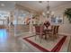 Elegant dining room showcasing a chandelier and columns leading to the kitchen at 1239 Russell Loop, The Villages, FL 32162