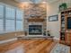 Stone fireplace with wooden mantle and gas insert at 1239 Russell Loop, The Villages, FL 32162