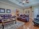 Inviting living room featuring hardwood floors and a comfortable seating arrangement at 1239 Russell Loop, The Villages, FL 32162