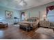 Comfortable main bedroom featuring a ceiling fan, matching dressers, lamps, and bench at the foot of the bed at 1239 Russell Loop, The Villages, FL 32162