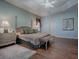 Comfortable main bedroom featuring a ceiling fan, matching dressers, lamps, and bench at the foot of the bed at 1239 Russell Loop, The Villages, FL 32162