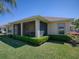 Charming home featuring a screened lanai, manicured lawn, and well-maintained landscaping at 1239 Russell Loop, The Villages, FL 32162