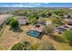 Aerial view of a house with a screened-in pool surrounded by lush greenery, offering privacy and tranquility at 12620 Bay Breeze Ct, Clermont, FL 34711