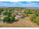 An aerial shot showcases the home's screened pool and large lot backing up to a lake in a beautiful neighborhood at 12620 Bay Breeze Ct, Clermont, FL 34711