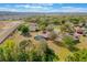 Drone shot of a spacious residence featuring an enclosed pool area, set in a serene, wooded neighborhood by a lake at 12620 Bay Breeze Ct, Clermont, FL 34711