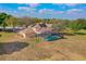 Aerial view of a house with a screened-in pool and a large backyard, perfect for outdoor activities at 12620 Bay Breeze Ct, Clermont, FL 34711