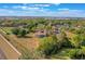 An aerial shot of the home reveals an enclosed pool and sprawling backyard with distant lake views at 12620 Bay Breeze Ct, Clermont, FL 34711