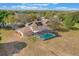 Aerial view of a house with a screened-in pool and a large backyard, perfect for outdoor activities at 12620 Bay Breeze Ct, Clermont, FL 34711