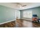 Light and airy bedroom with a ceiling fan, wood-look floors, and a bright window at 12620 Bay Breeze Ct, Clermont, FL 34711