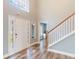 Inviting entryway featuring hardwood floors and a staircase leading to the upper level at 12620 Bay Breeze Ct, Clermont, FL 34711