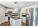 Modern kitchen featuring white cabinets, stainless steel appliances, and pendant lighting at 12620 Bay Breeze Ct, Clermont, FL 34711