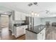 Modern kitchen with granite countertops, stainless steel refrigerator, and hanging pendant lights at 12620 Bay Breeze Ct, Clermont, FL 34711