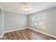 Bright living room featuring modern wood flooring and a large window, offering a welcoming space at 12620 Bay Breeze Ct, Clermont, FL 34711