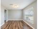 Bright living room featuring modern wood flooring and a large window, offering a welcoming space at 12620 Bay Breeze Ct, Clermont, FL 34711