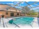 Enjoy the Florida sun by this screened in pool with a covered lanai and outdoor dining area at 12620 Bay Breeze Ct, Clermont, FL 34711