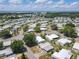 Wide aerial view showcasing the community's layout, streets, and nearby lake at 1312 Apache Cir, Tavares, FL 32778