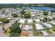 Aerial view of the community highlighting the layout, streets, and nearby lake at 1312 Apache Cir, Tavares, FL 32778