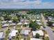 Scenic aerial view of community, surrounded by lush trees and a baseball field at 1312 Apache Cir, Tavares, FL 32778
