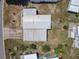 Aerial view of the home showcasing the roof condition, landscaping, and nearby streets at 1312 Apache Cir, Tavares, FL 32778