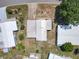 An aerial view displays the home's roof, driveway, and surrounding yard at 1312 Apache Cir, Tavares, FL 32778