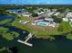 Aerial shot of the lakeside community featuring a pool, lake access, and walking trails at 1312 Apache Cir, Tavares, FL 32778