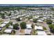 An aerial photo displaying the neighborhood's arrangement, tree coverage and street design at 1312 Apache Cir, Tavares, FL 32778