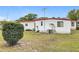 The house features a backyard with grass and a satellite dish at 1312 Apache Cir, Tavares, FL 32778