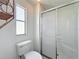 Bathroom with toilet and standing shower with sliding glass door at 1312 Apache Cir, Tavares, FL 32778