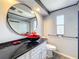 Stylish bathroom featuring dark marble countertop and a striking vessel sink and modern fixtures at 1312 Apache Cir, Tavares, FL 32778