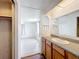 Bathroom sink and cabinet. Laminate floors are shown through the doorway at 1312 Apache Cir, Tavares, FL 32778