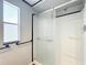 Bright bathroom featuring shower with glass doors and window, offering natural light at 1312 Apache Cir, Tavares, FL 32778