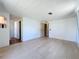 Bedroom with light wood laminate flooring and white walls, offering a clean and bright space at 1312 Apache Cir, Tavares, FL 32778