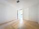 Spacious bedroom with light wood floors and an open doorway to a bathroom at 1312 Apache Cir, Tavares, FL 32778